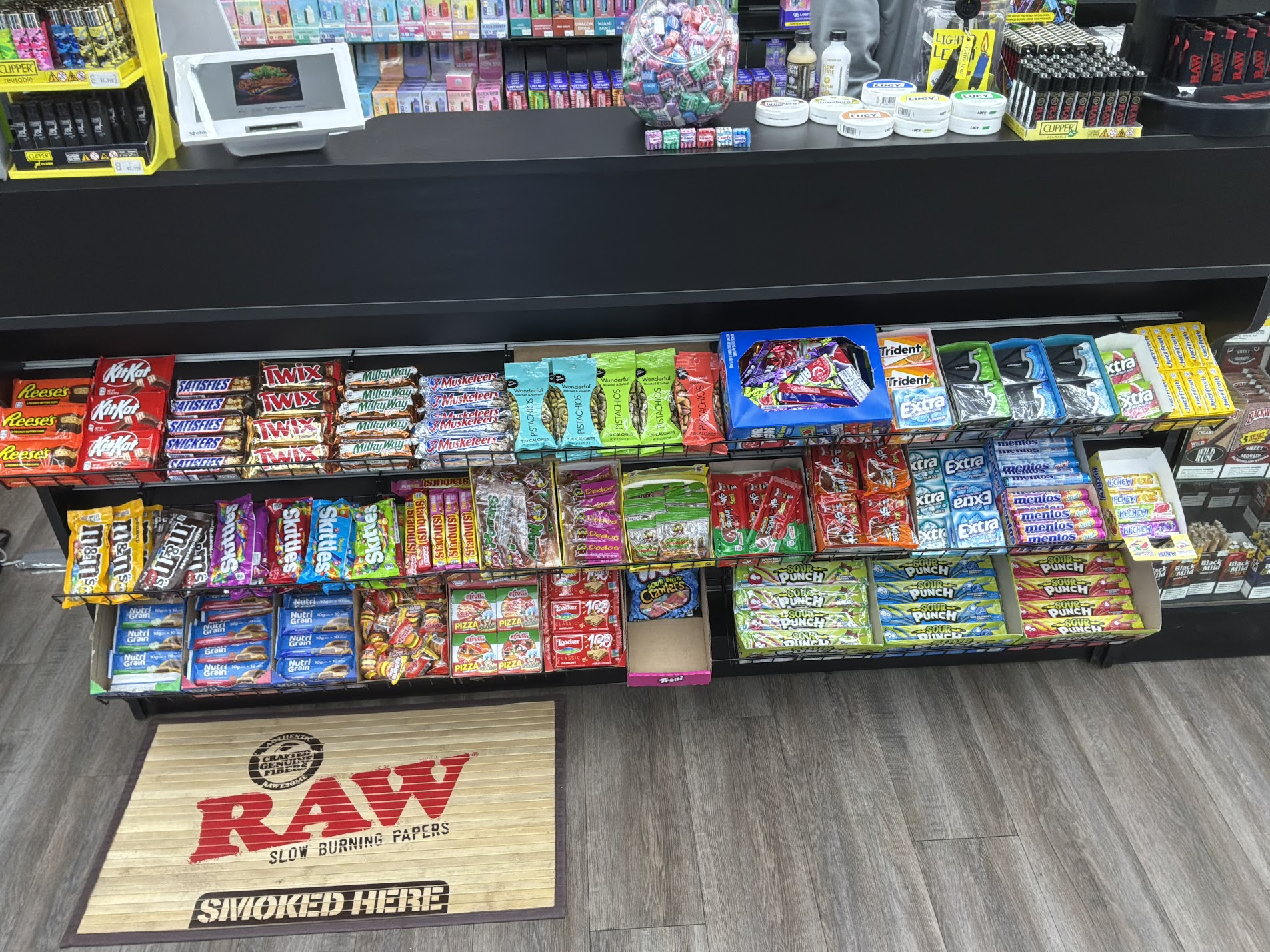 Candy and snack aisle with RAW Smoked Here mat